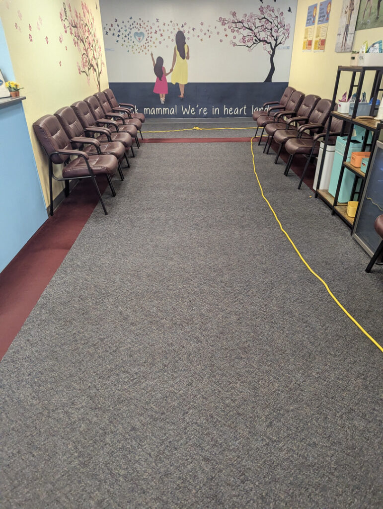 carpet cleaning service in a waiting area with chairs and a power cord on the floor