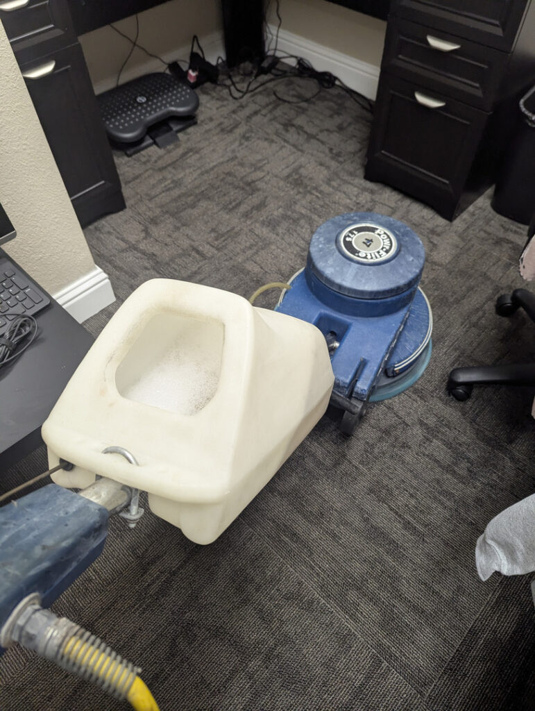 carpet cleaning using a rotary machine with a solution tank in an office setting