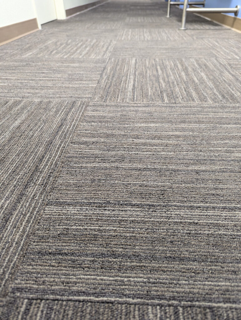 clean carpet tiles in a hallway with a modern design and neutral colors